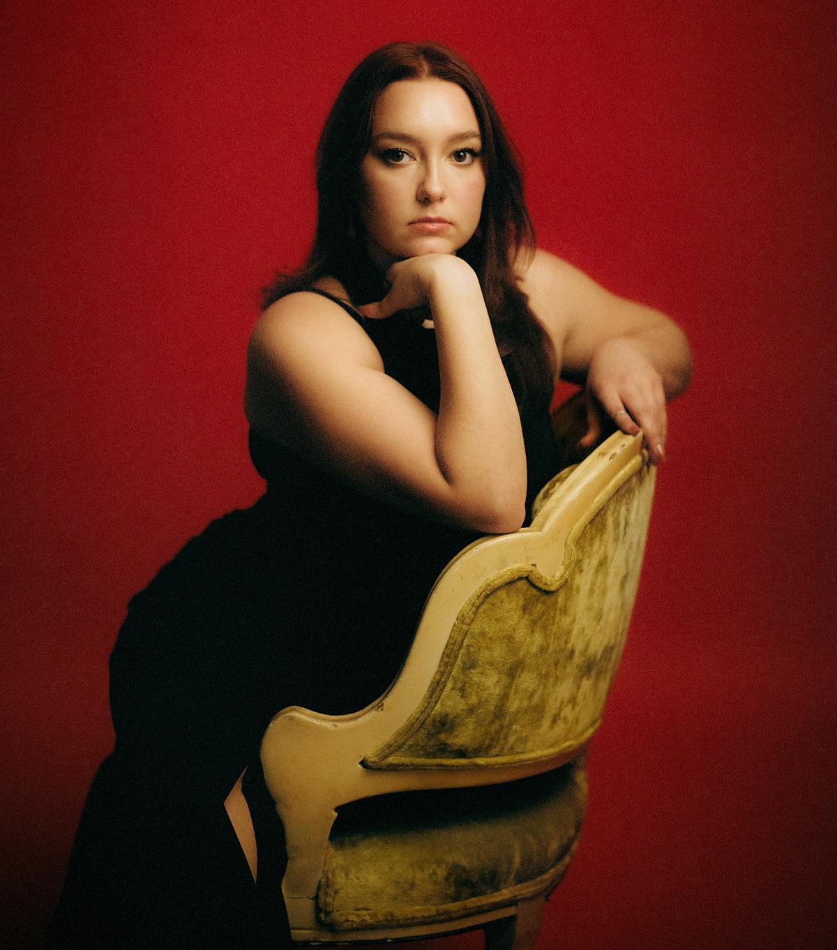 Joie Bianco sitting on a chair