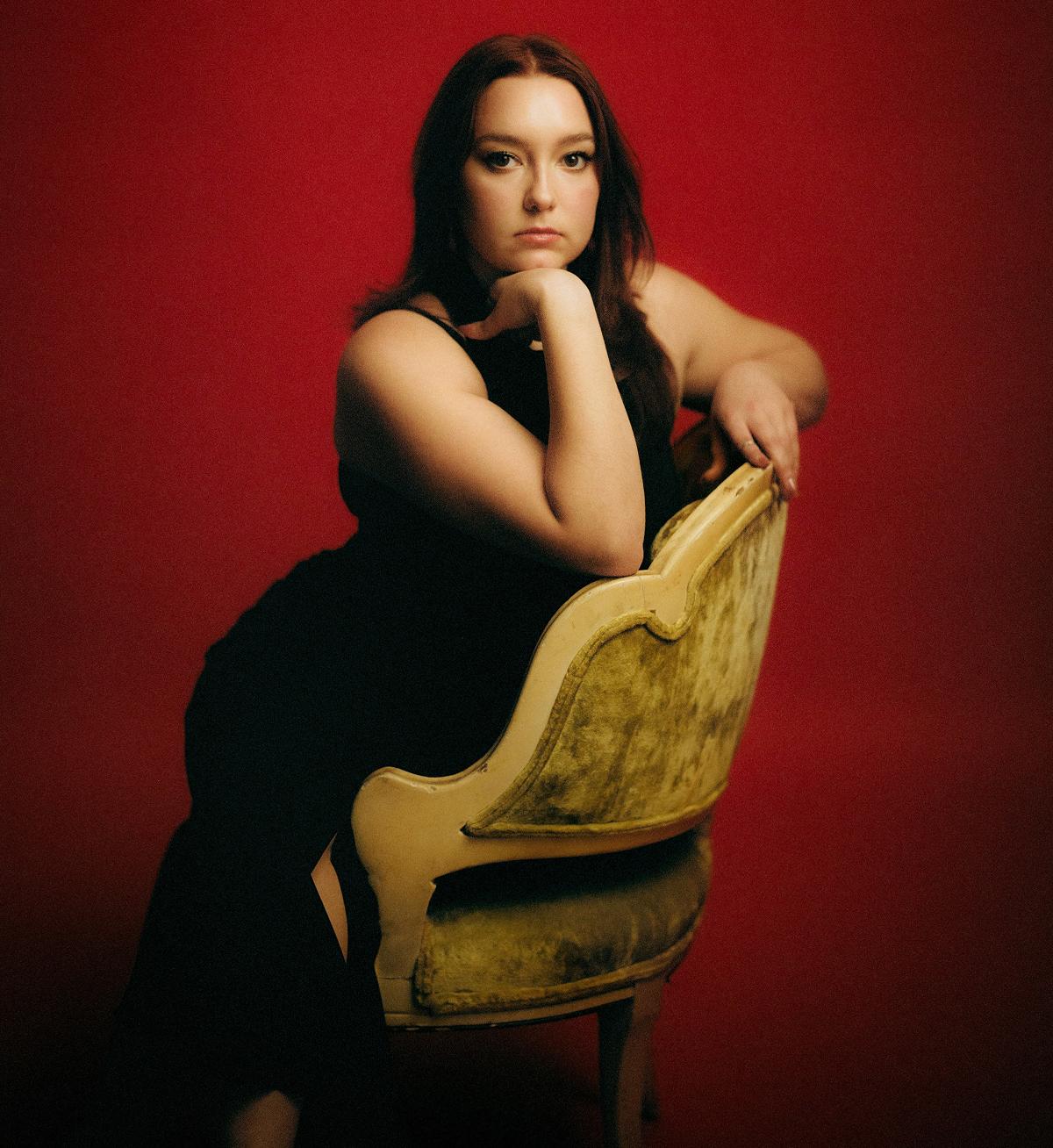 Joie Bianco seated in a chair